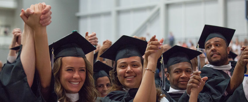 graduates holding hands