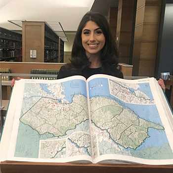 Rebecca Howard in 2022, holding a map of New Jersey