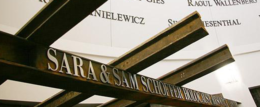 Railroad tracks hang above the entrance to the Holocaust Resource Center