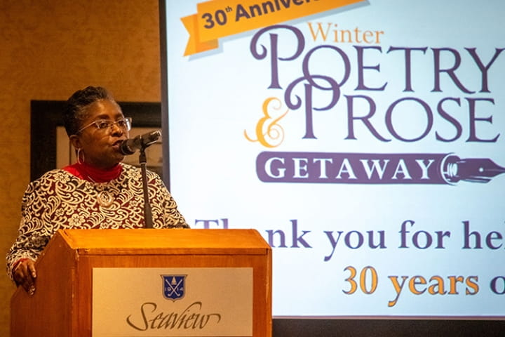 woman speaks at podium