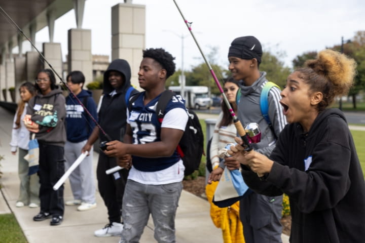 students using fishing rods