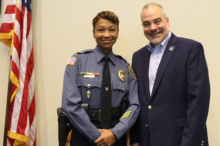 Chief Tracy Stuart in her police uniform next to President Joe Bertolino
