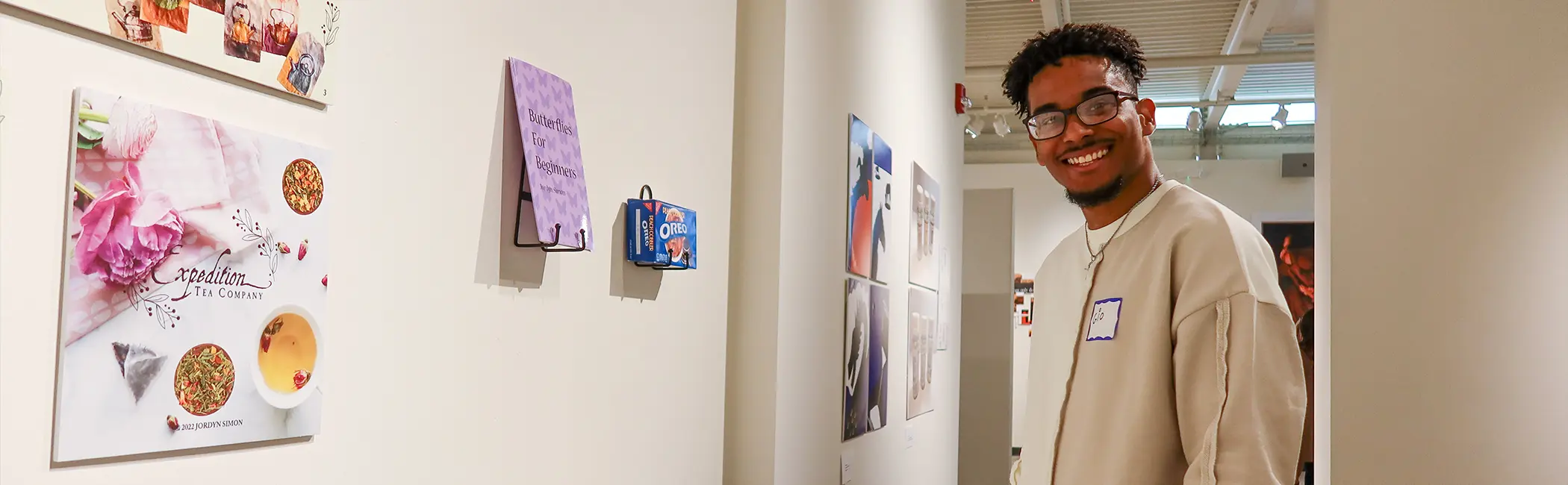 Student artwork displayed in a Stockton University Visual Arts gallery, highlighting creative design, mixed media, and real-world exhibition experience.