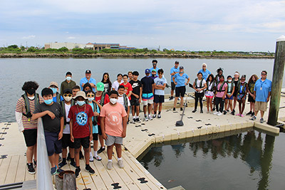 Summer Youth Rowing Camp participants on the docks