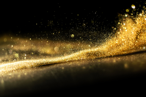 Stock image of gold sparkles against a black background