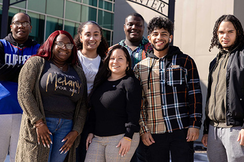 Jovin Fernandez (center) with students in front of the Multicultural Center