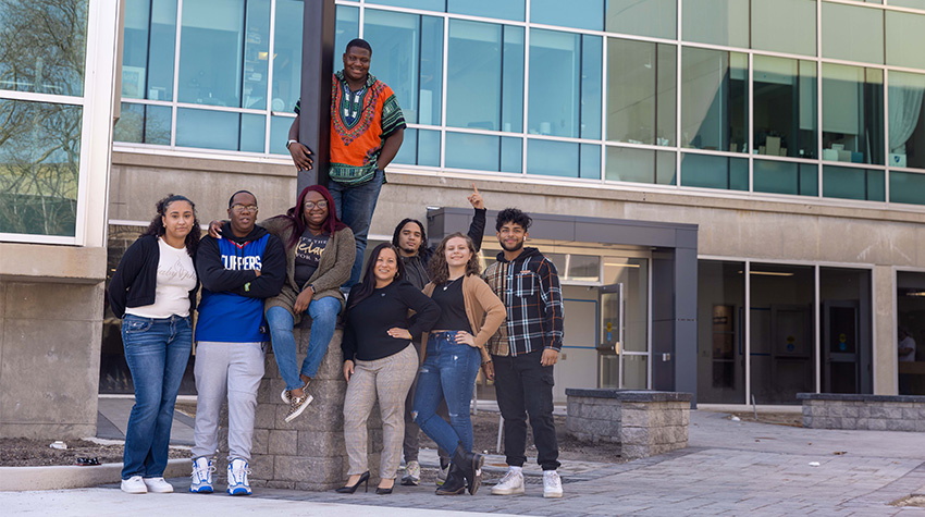Jovin and students in front of the Multicultural Center