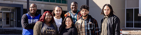 Jovin and students in front of Multicultural Center