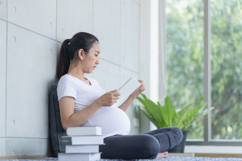 Stock image of a pregnant student studying