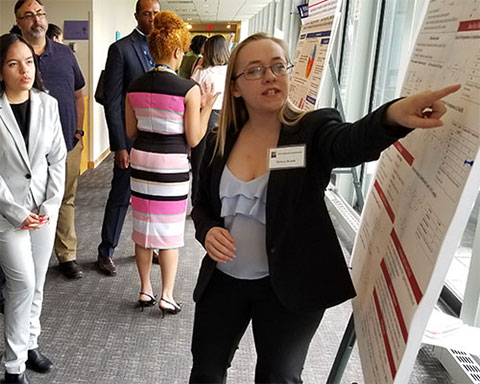 Tiffany Roach, Stockton 2019 is pictured presenting a research poster at the Yale Bouchet Conference while an undergraduate student