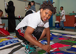 Young student shown at a service learning event
