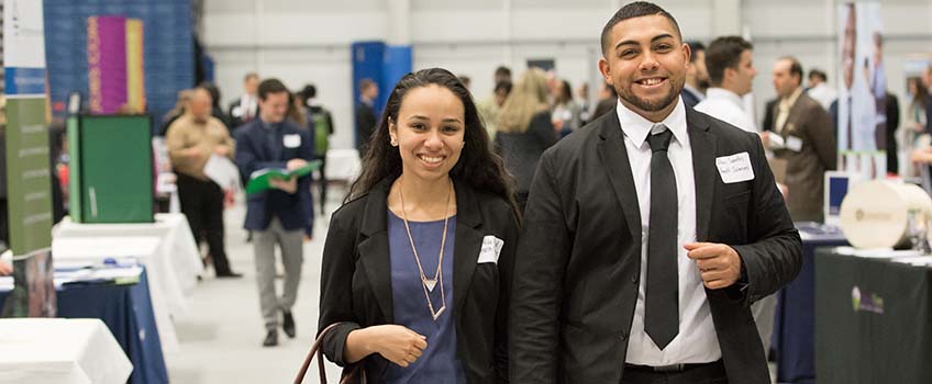 Two students networking at a career fair