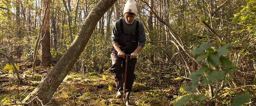 A man collects a soil sample