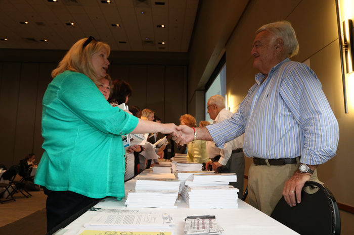 Holocaust Survivor Don Berkman shaking hands with an event participant at the book signing.