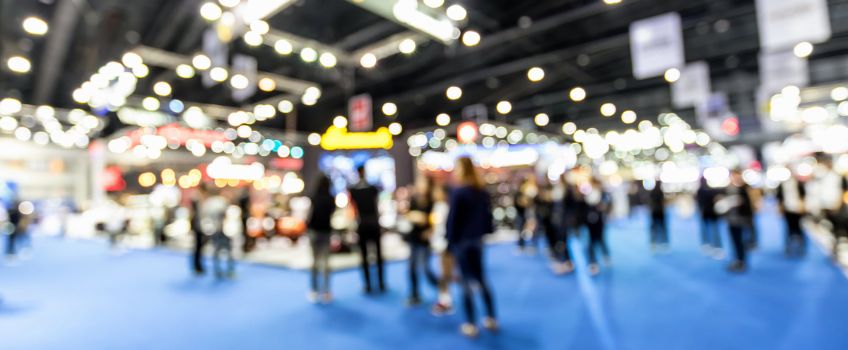 Out of focus wide view of trade convention exhibit space Out of focus wide view of trade convention exhibit space