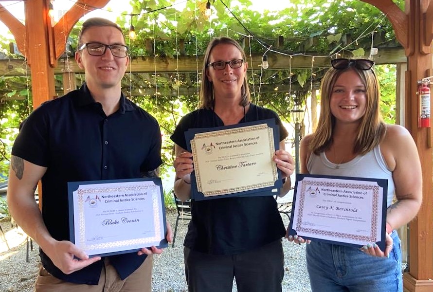 students and teacher with award