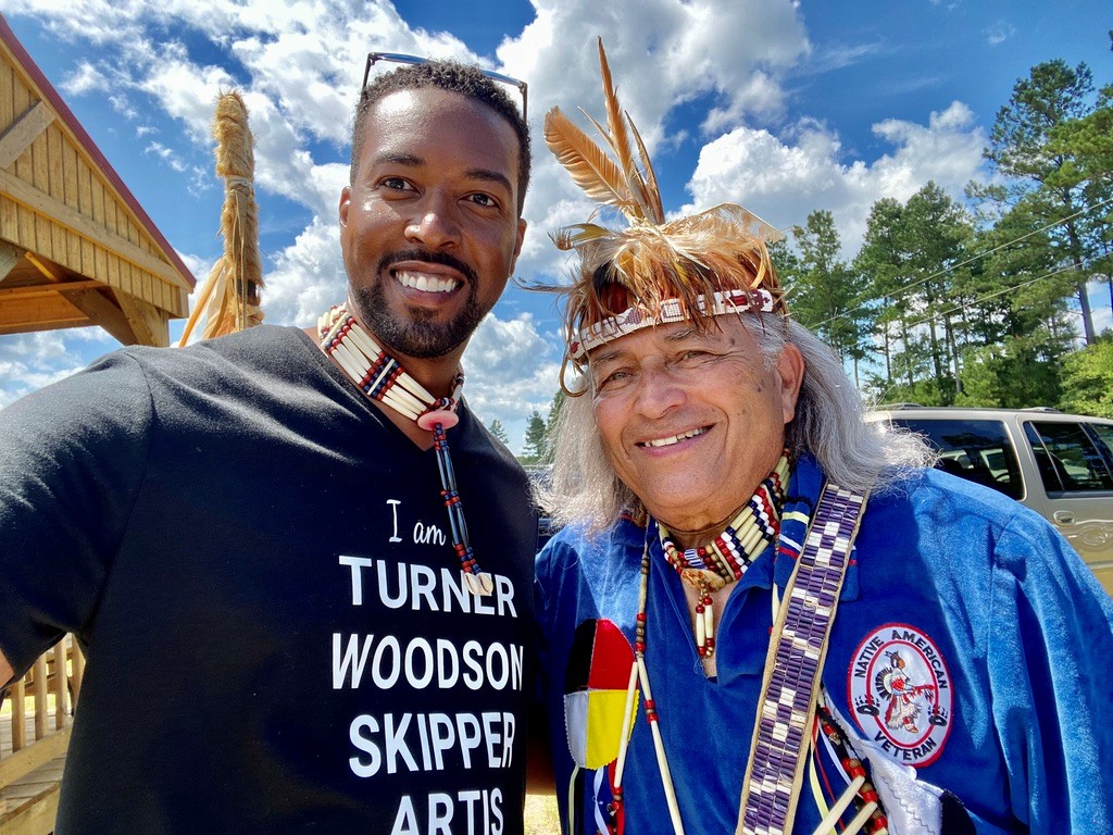 Aaron "Great River Moon" Moss, assistant professor of Theatre/Directing at Stockton, poses with a photo with his cousin Cheroenhaka/Nottoway Chief Walter “Red Hawk” Brown.