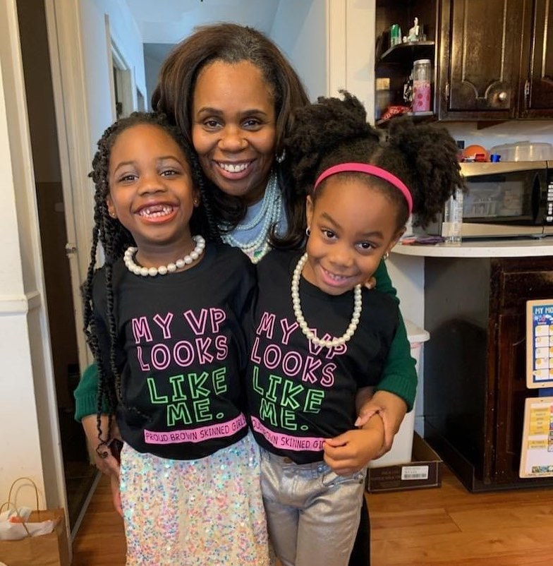 Associate Professor of Social Work Dr. Maya Lewis poses with her twin girls on Inauguration Day as they watch Kamala Harris sworn in as the first woman Vice President of the United States