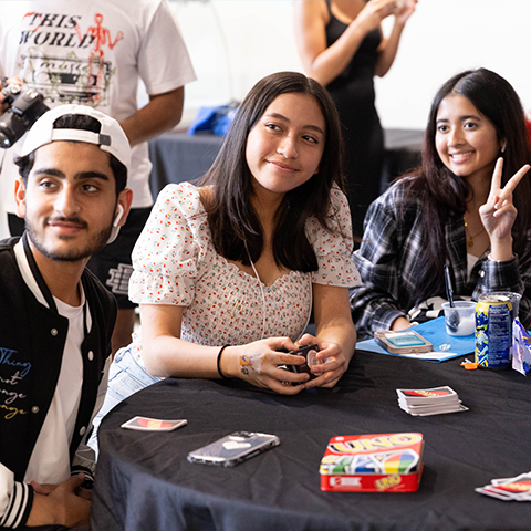 Students playing Uno, posing for photos