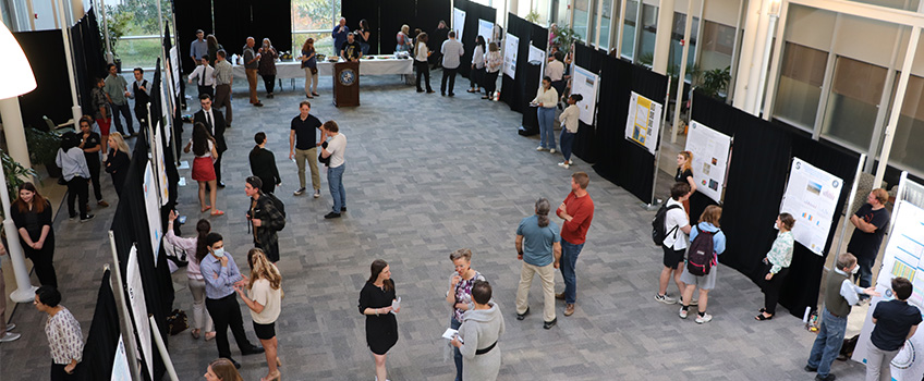 People filed in and out of the C-D Atrium on April 22 to chat with undergraduate students in the School of Natural Sciences and Mathematics about their research projects.