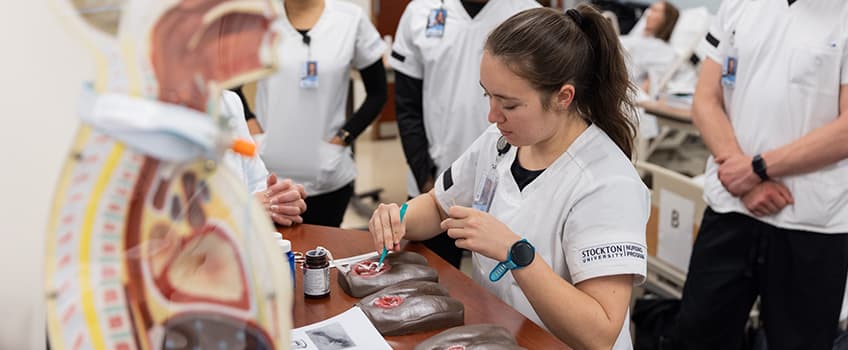 stockton university nursing student running a test