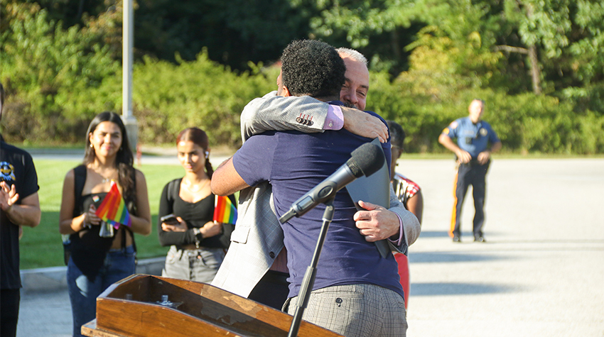 President Joe Bertolino hugging Marques Johnson 