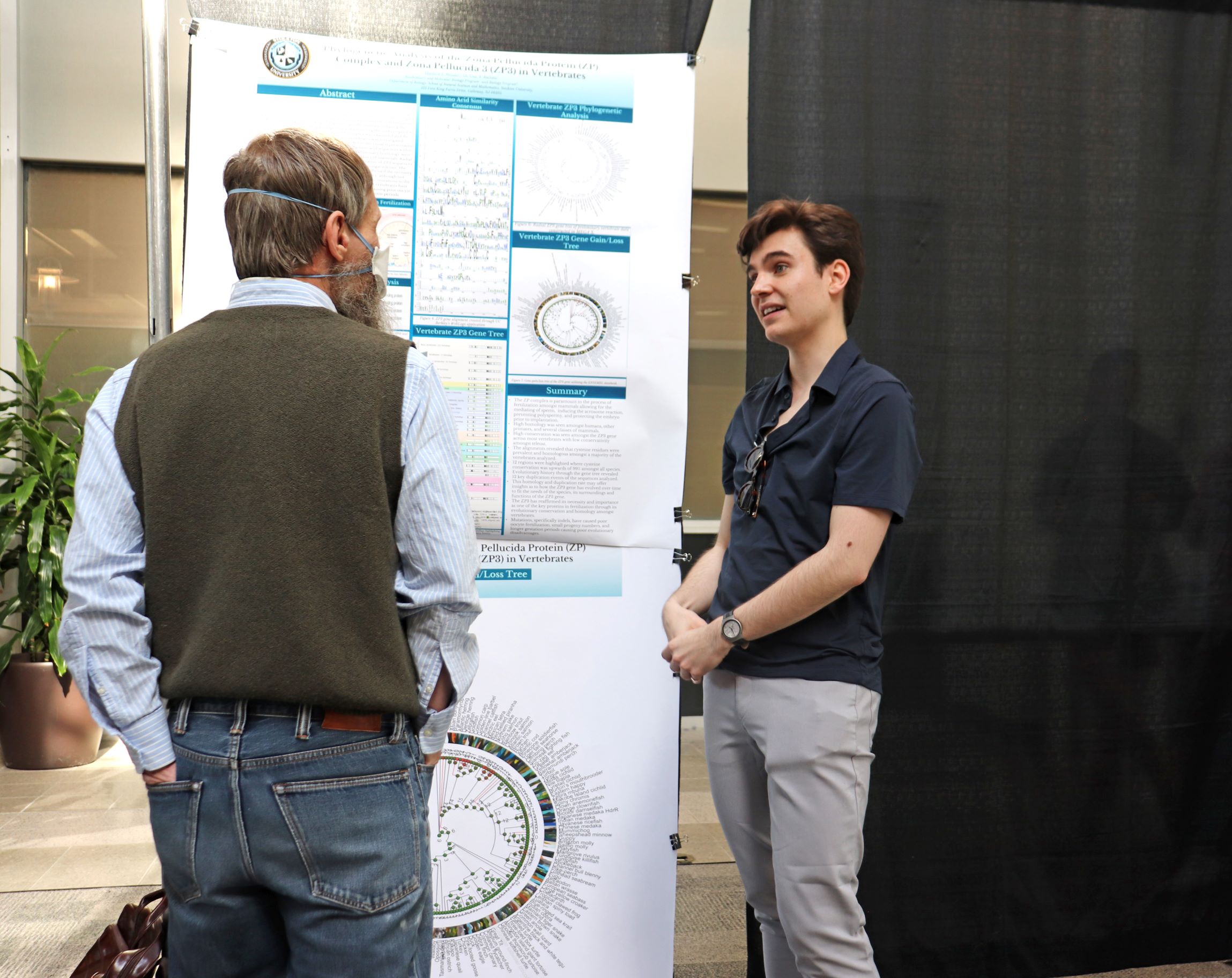 Matthew Metzler was an honorable mention in the NAMS Symposium on April 22. He stands in front of his project and chats with a faculty member.