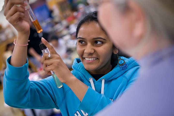 Photo of student in a chemistry lab with instructor