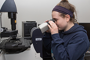 Image of student looking through the Leica Microsystems Microscope