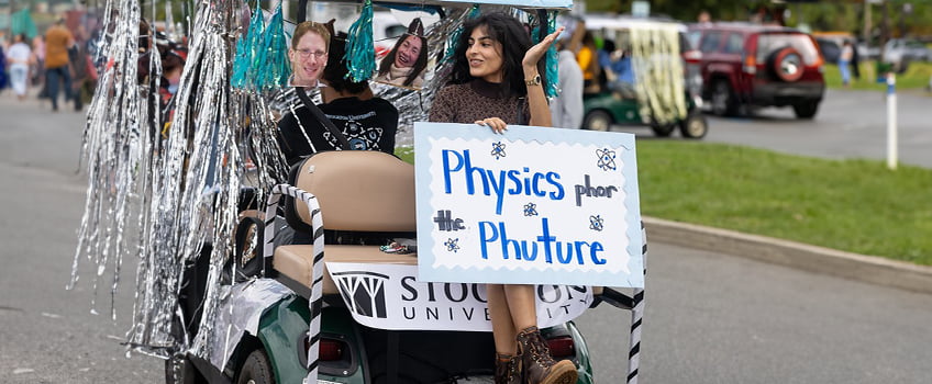Students participate in a campus parade for the Physics club