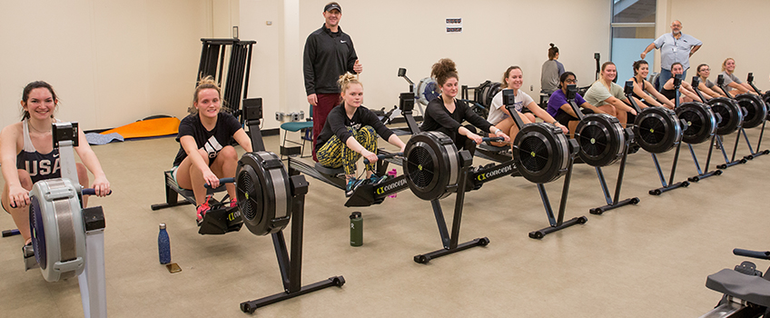 female students on rowing machines