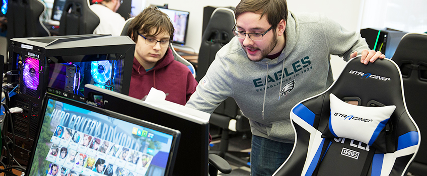 Ryan Steup and Brian Kibelstis discuss gaming strategy in the new esports facility. Below, Dianna Marinelli and Alex Lee play on Stockton teams.