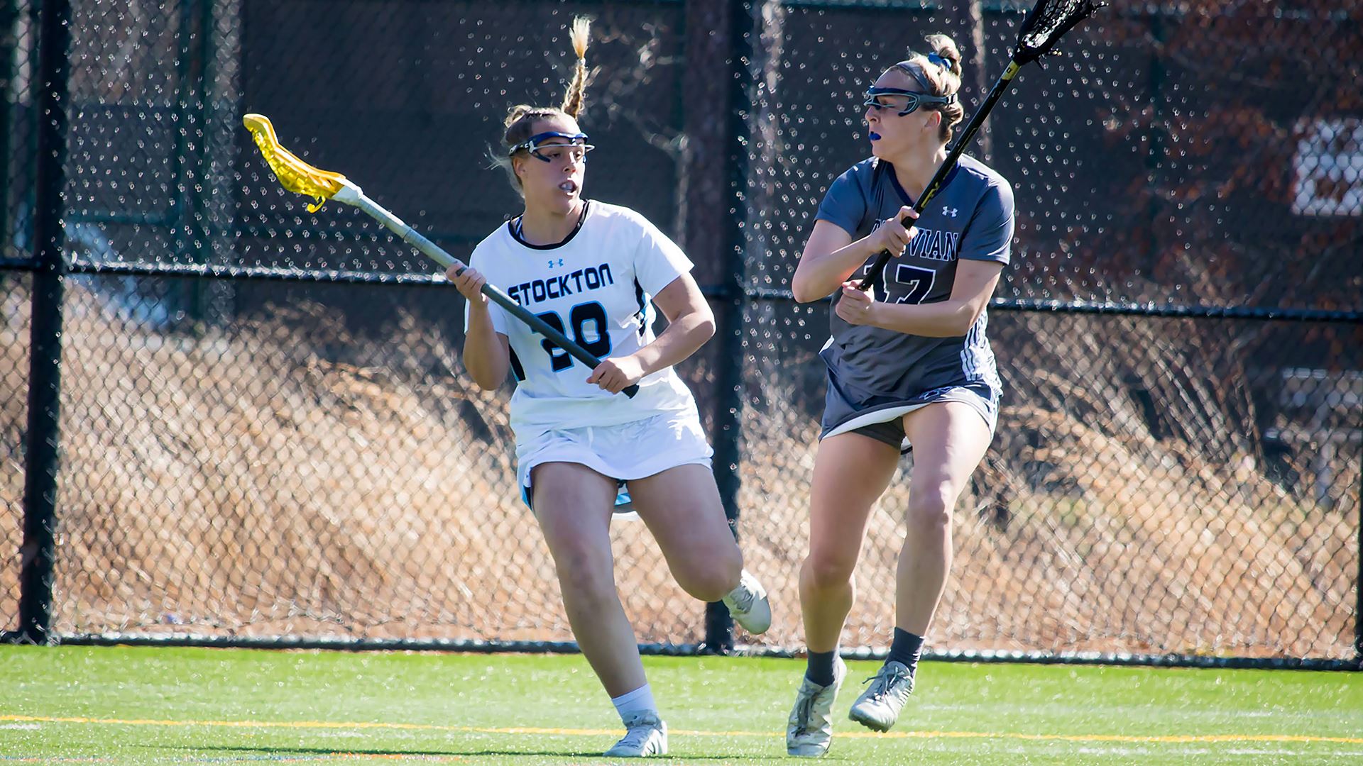 two women playing lacrosse 