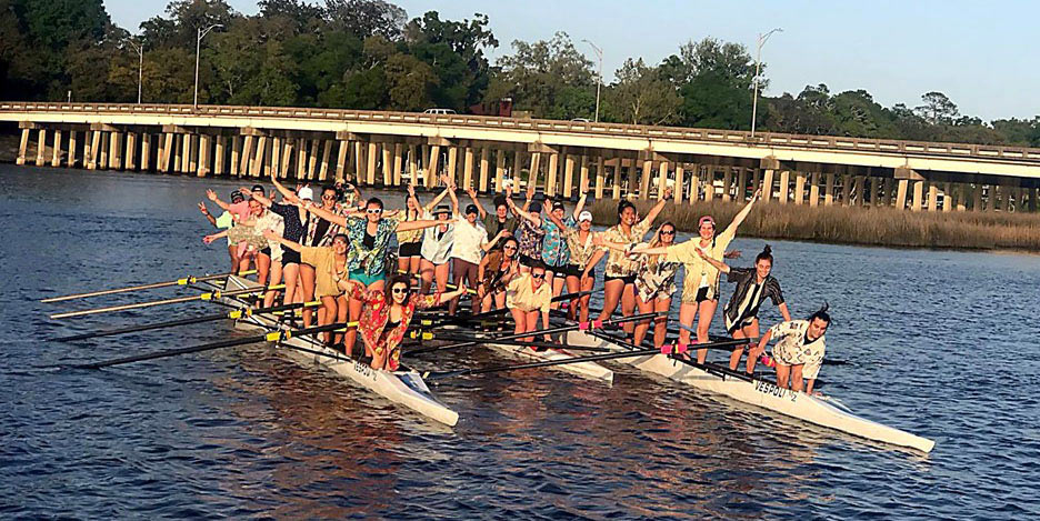  crew members standing in boat