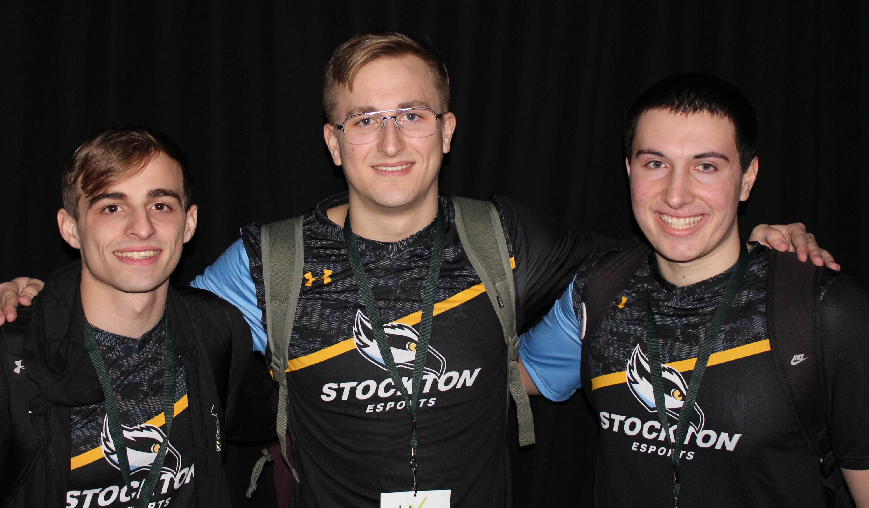 three male esports students smiling