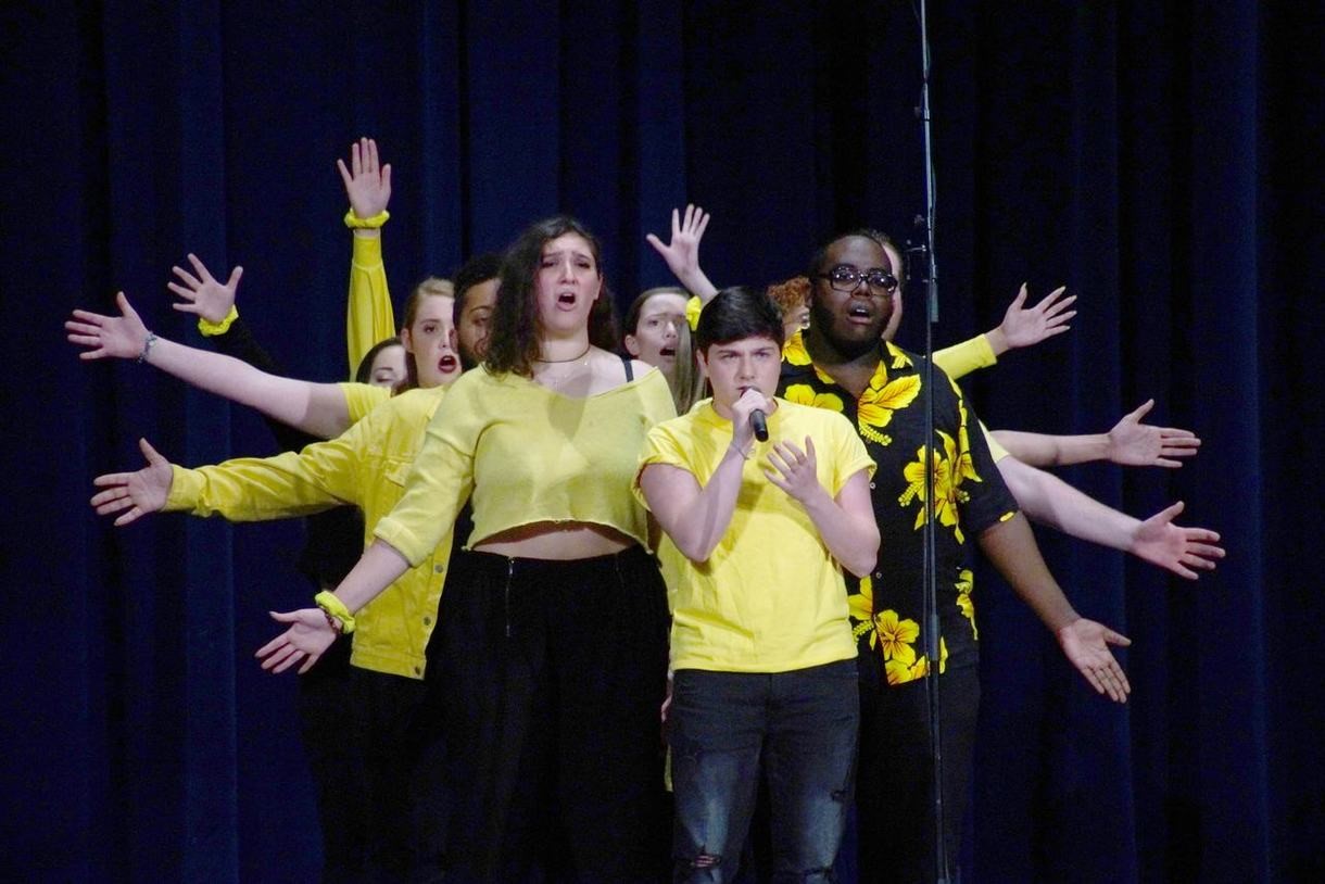 students singing on stage