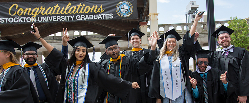 graduates celebrating on boardwalk 