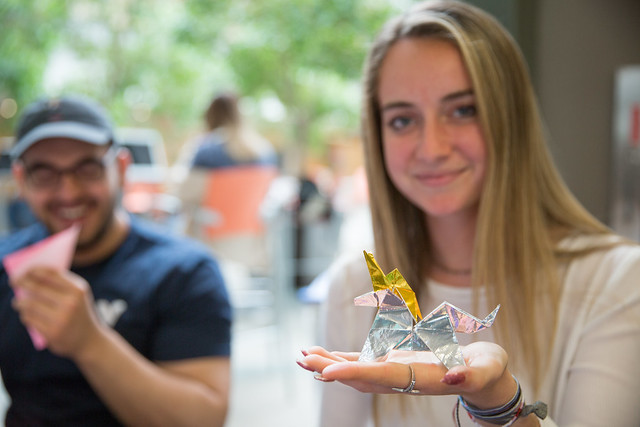 girl holding origami unicorn