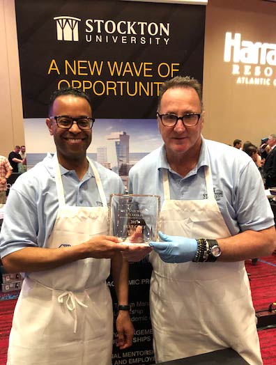 Jackson, left, holds his award alongside Michael Baker. 