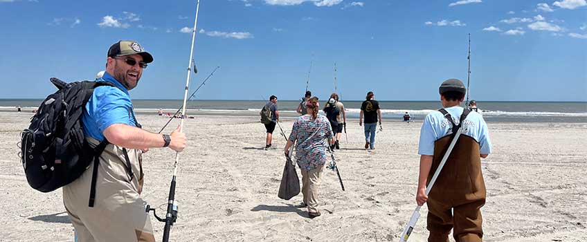 Adam Aguiar, assistant professor of Biology, leads Cedar Creek High School students on a fishing experience on the beach in front of Stockton Atlantic City during the New Angles for Success program.