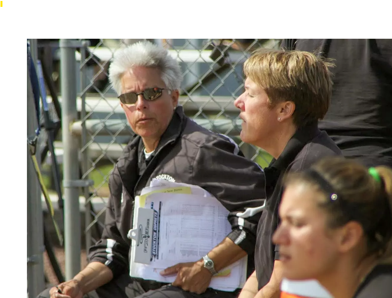 Val Julien sits on bleachers during softball game