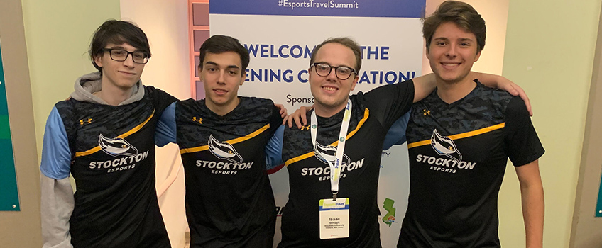 four esports players smiling 