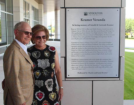 man and woman standing by plaque outside 