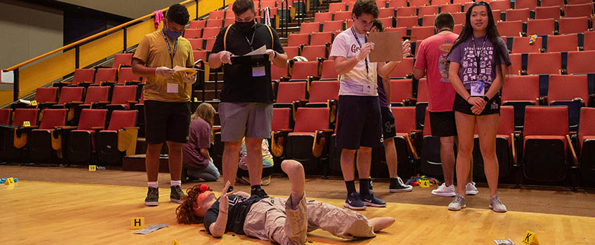 Campers collect and catalog evidence at the "crime scene" on the first day of CSI Camp.