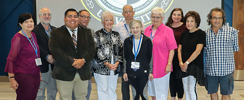 event presenters and coordinators smile for a photo