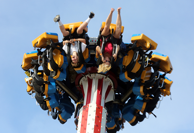 people upside down on amusement park ride 