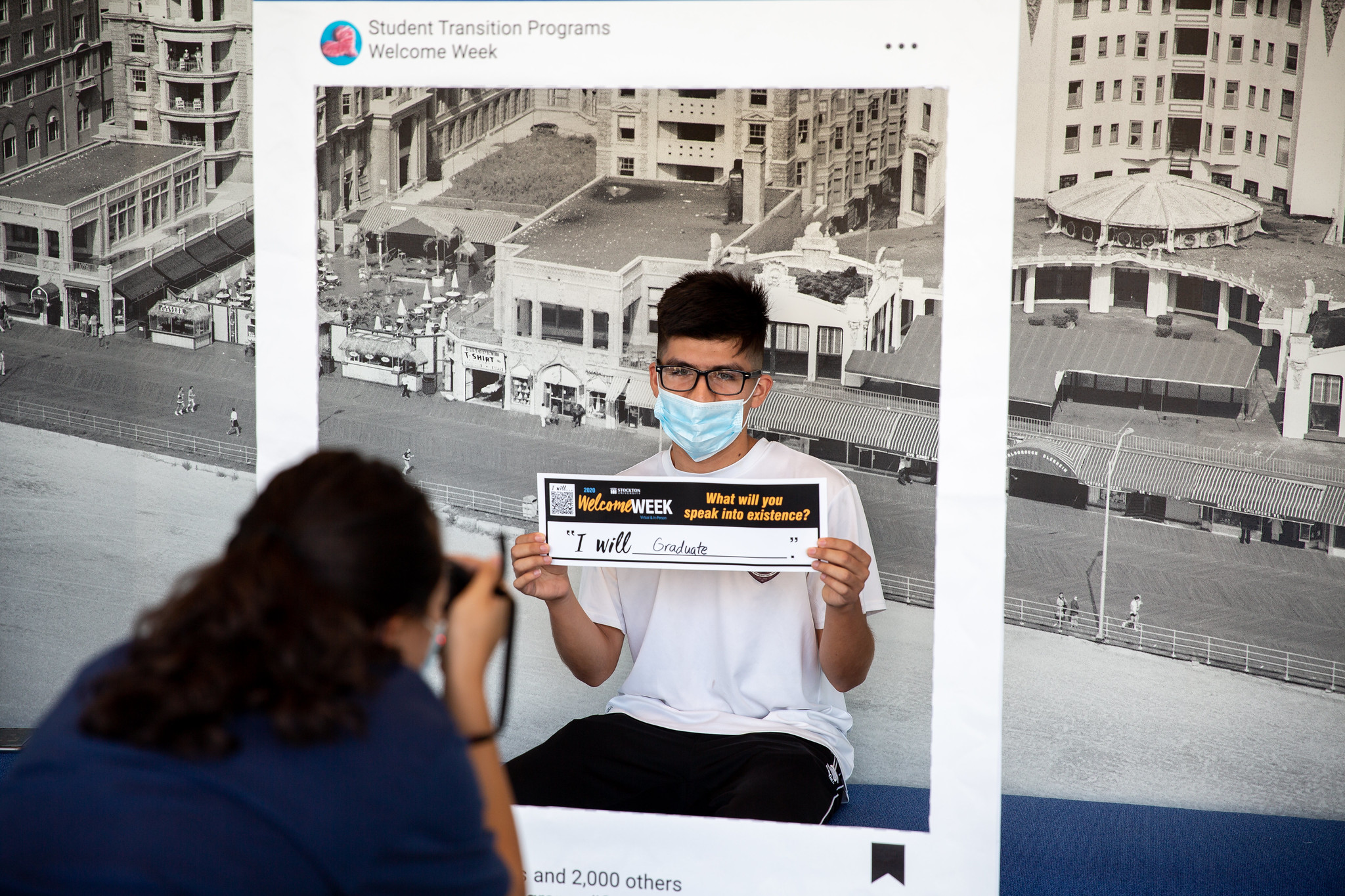 Student holding photo frame 