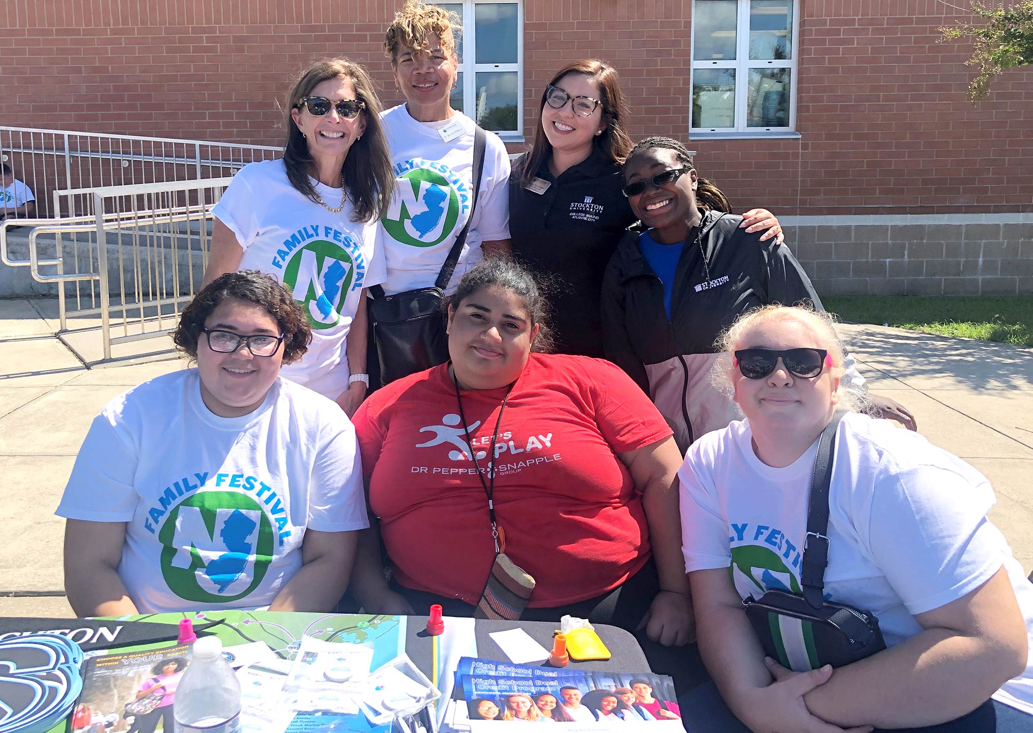 om left, First Lady of New Jersey Tammy Murphy; Maralyn Mason, executive director, Educational Opportunity and Success Programs; Roxana Perez Nieves, lead academic/career counselor for the College Bound Program; with Stockton Service-Learning students and alumni.