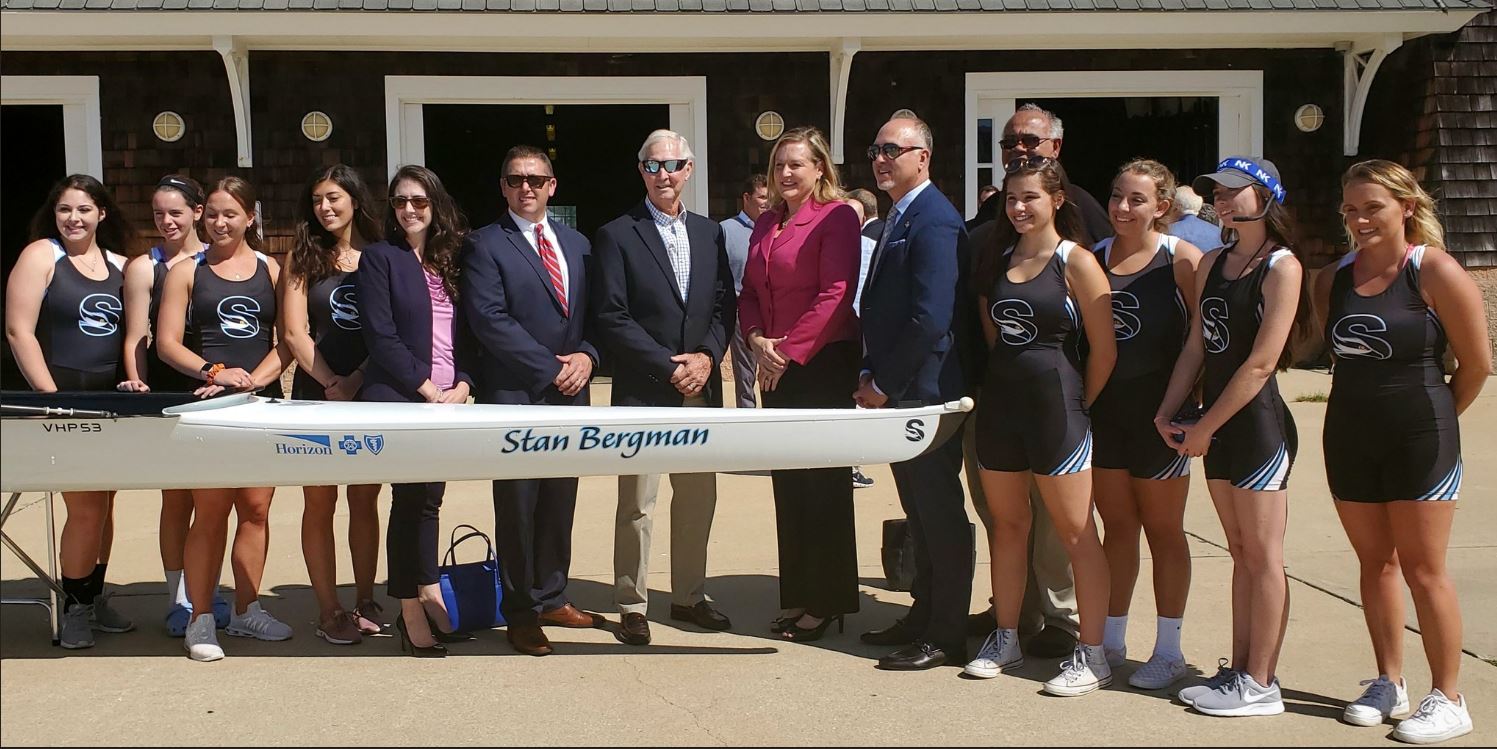 people standing next to rowing boat 