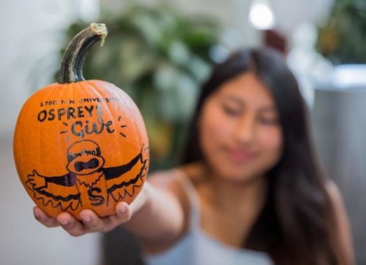 girl holding pumpkin